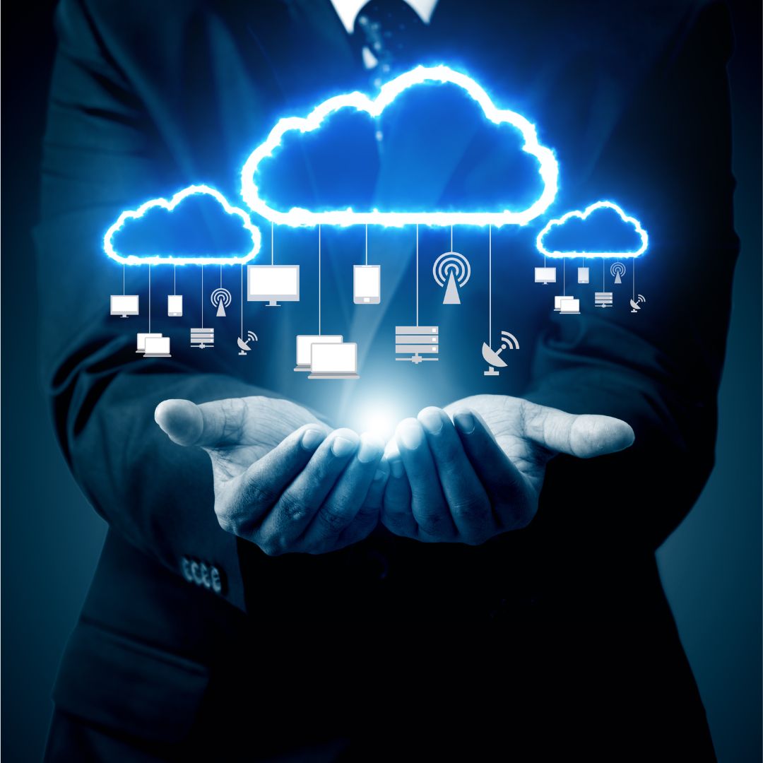 Cloud computing concept: A person holding a glowing cloud connected to various devices