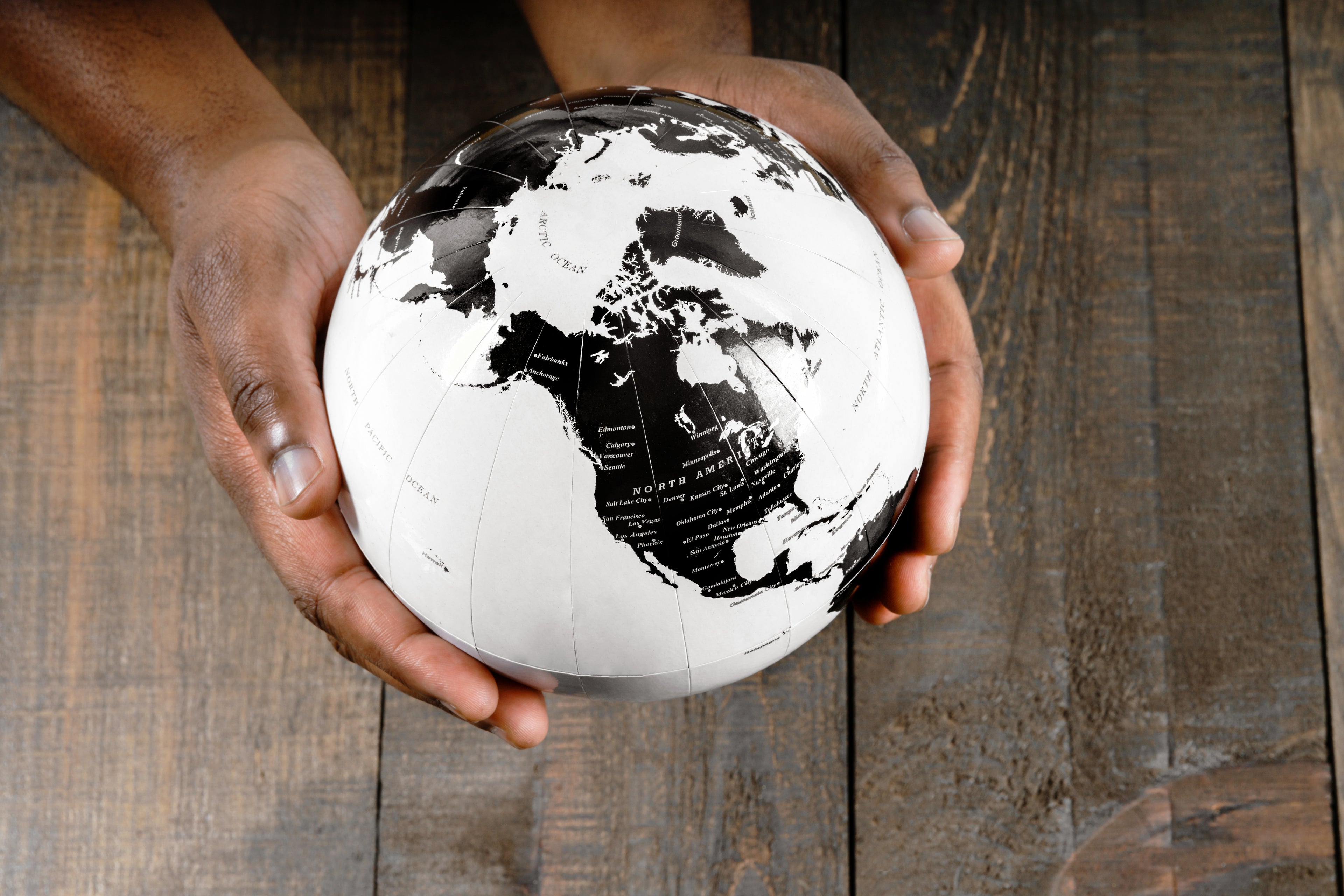 Hands holding a globe