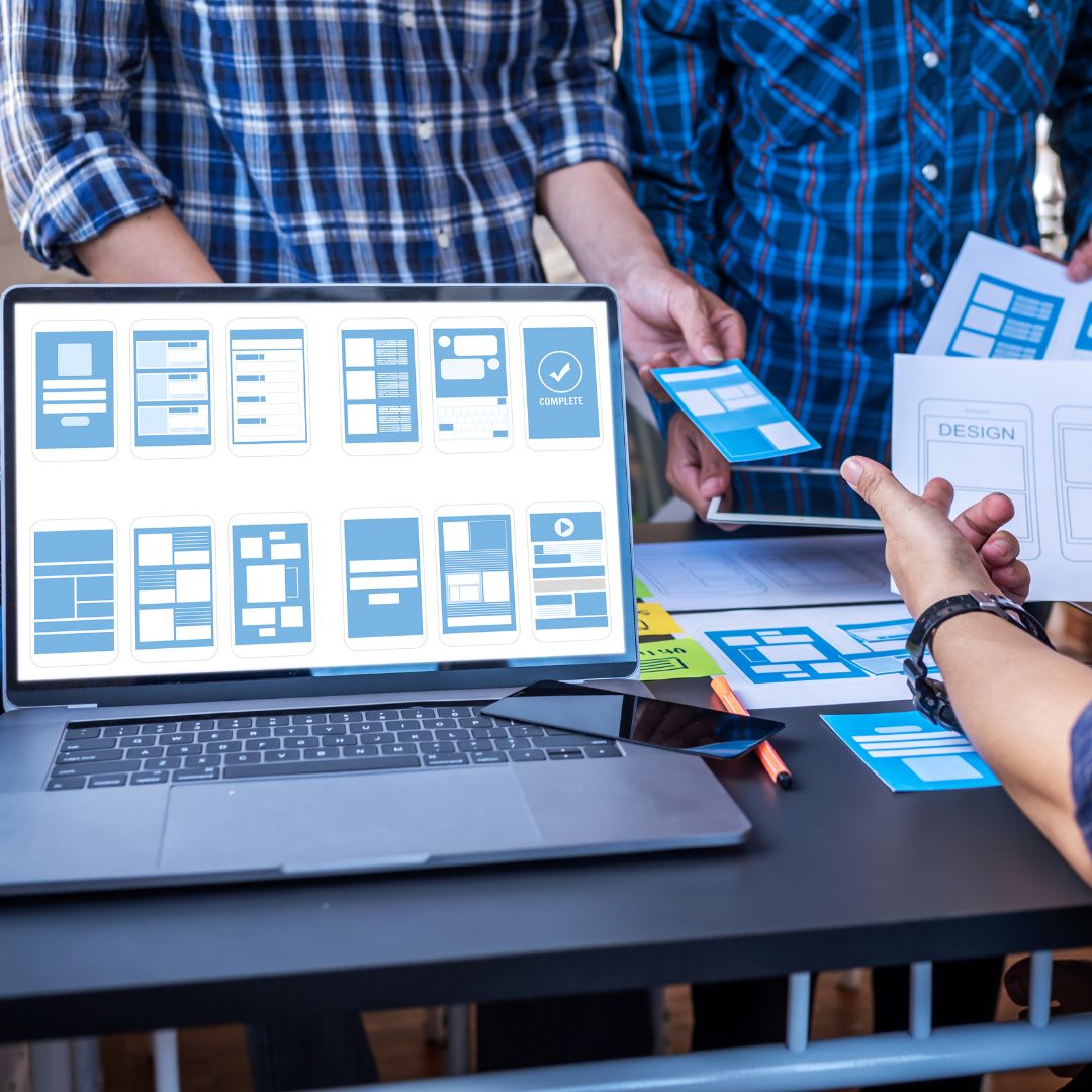 Team collaborates on UI/UX design with wireframes and mockups.