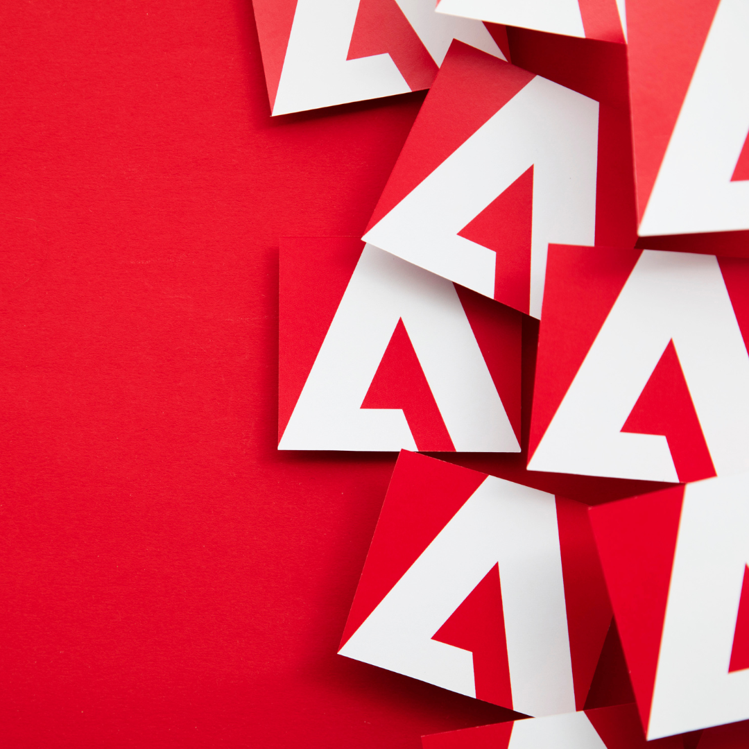Abstract arrangement of red and white cards forming a repeated 'A' pattern on a vibrant red background.