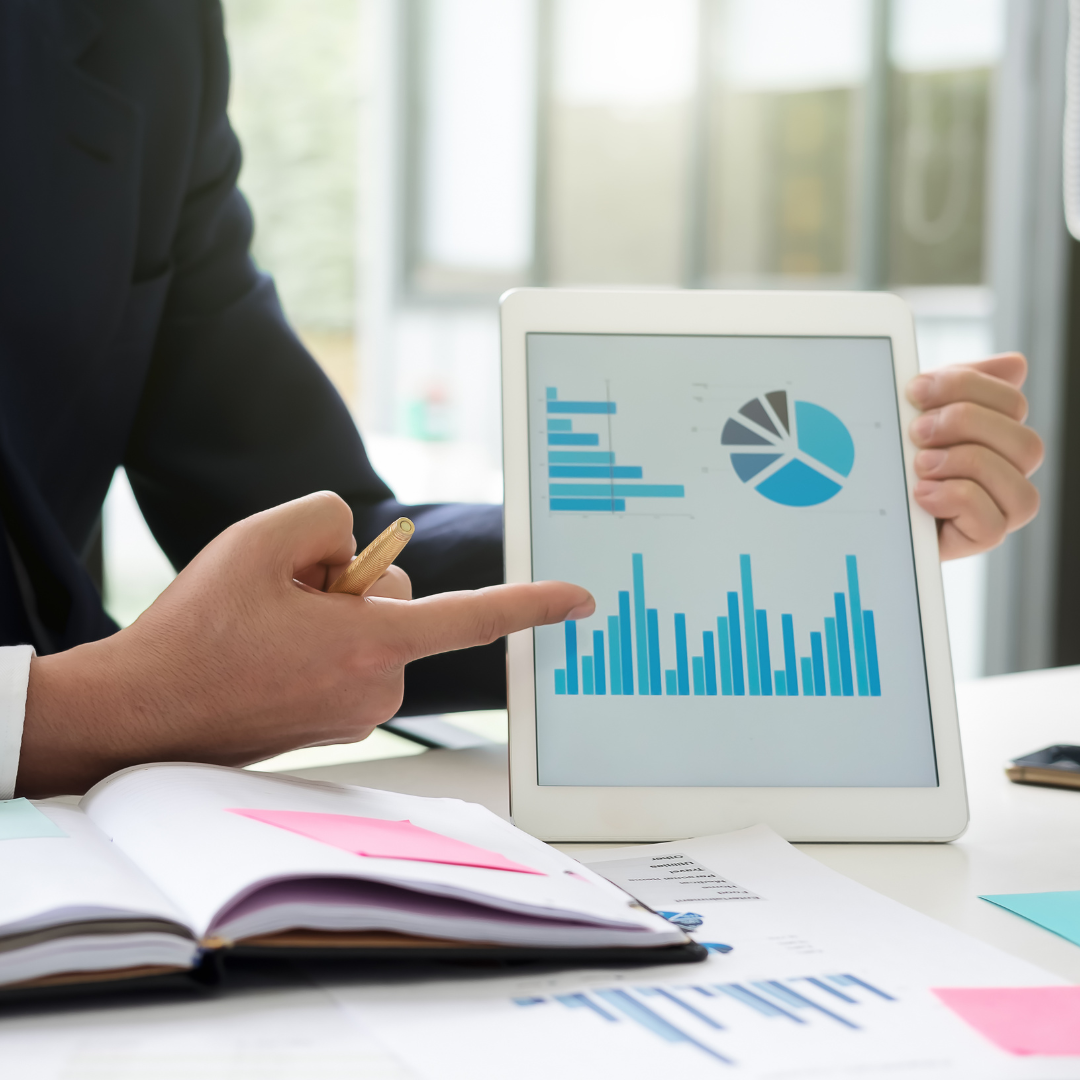 A finger pointing at a chart displaying growth.