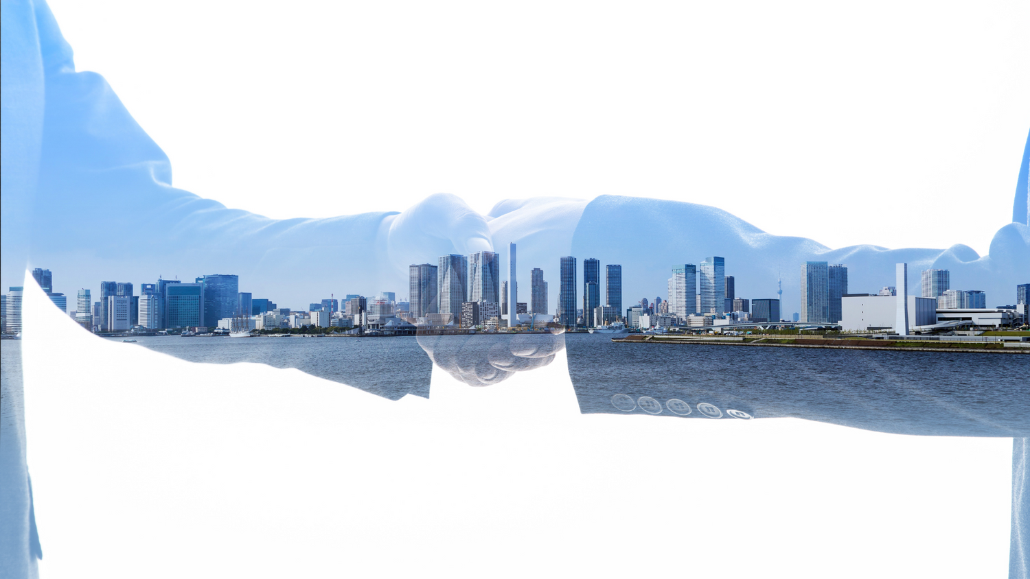 Double exposure of a handshake and a cityscape, symbolizing partnership and collaboration in urban development.