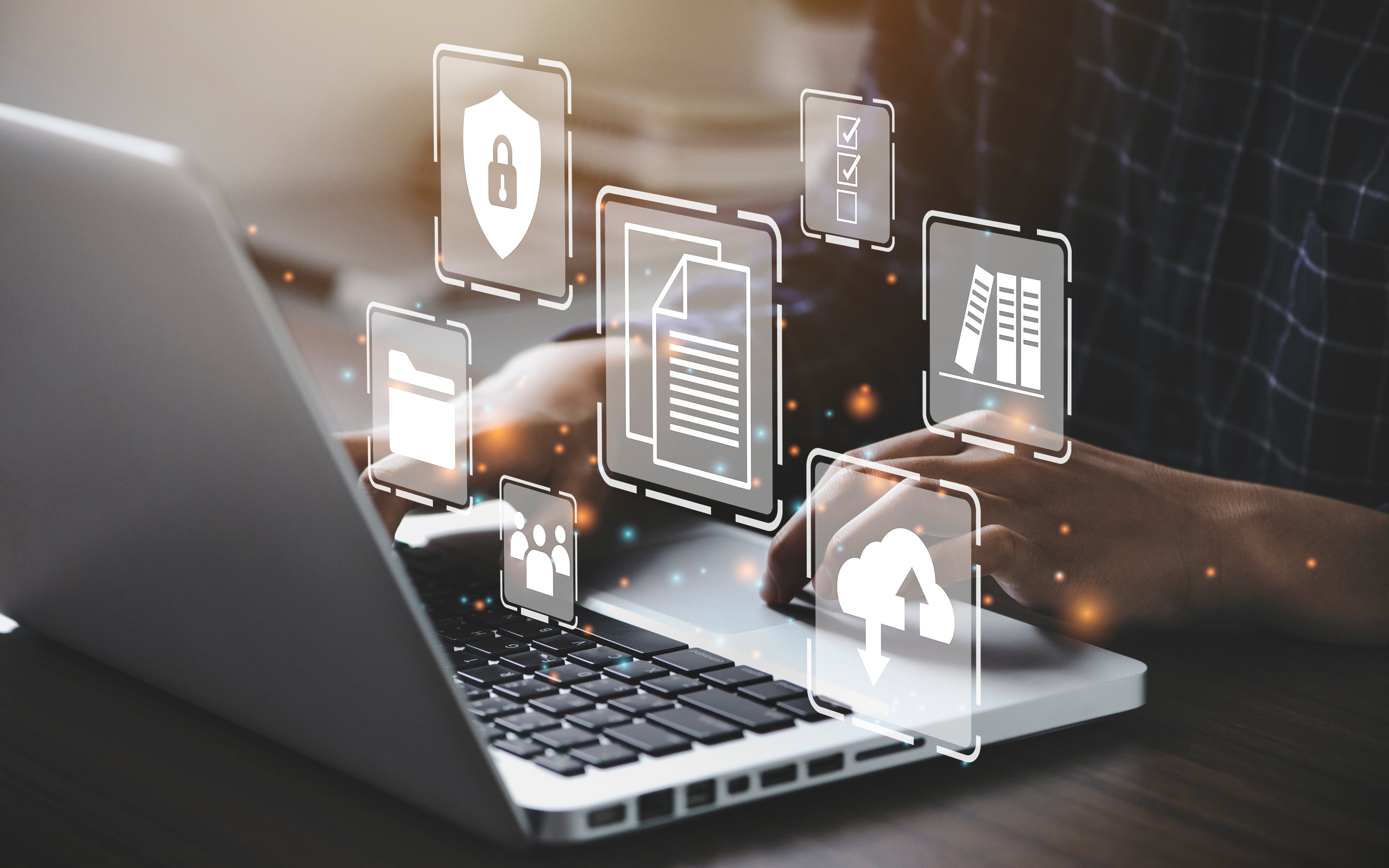 Person typing on a laptop with digital icons for data security, document management, and cloud services, highlighting cybersecurity.